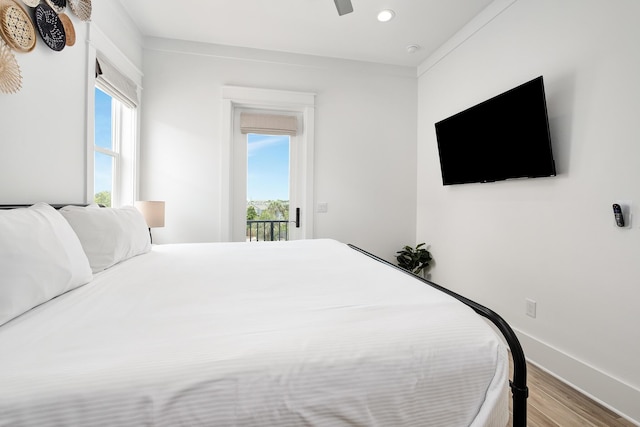 bedroom with ceiling fan, wood-type flooring, crown molding, and access to outside