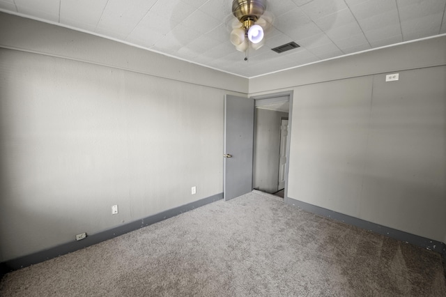 unfurnished bedroom featuring carpet floors, visible vents, and a ceiling fan