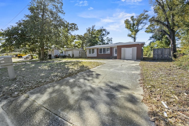 ranch-style home with fence