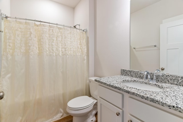 bathroom featuring vanity, toilet, and a shower with curtain