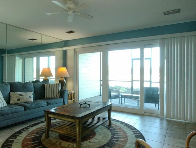 living room with ceiling fan and light tile patterned floors