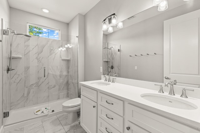 bathroom featuring vanity, toilet, and a shower with door