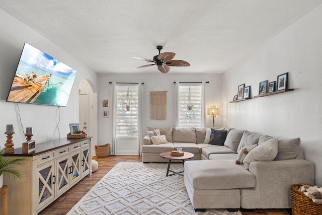 living room featuring hardwood / wood-style floors, a textured ceiling, and ceiling fan