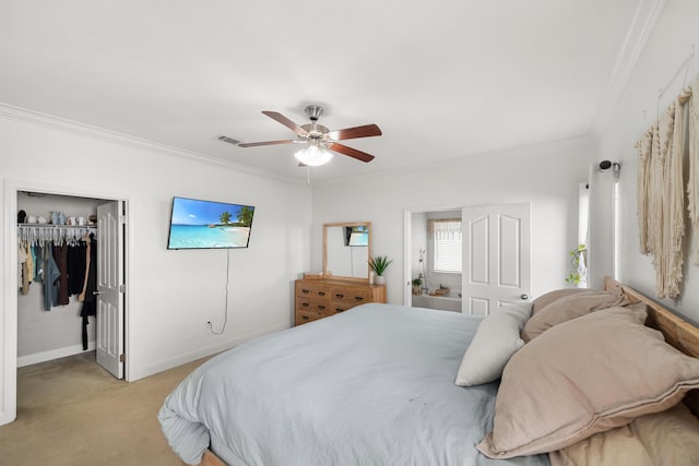 carpeted bedroom with ornamental molding, a walk in closet, ceiling fan, and a closet