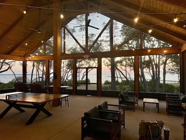 sunroom / solarium featuring wood ceiling, lofted ceiling with beams, and ceiling fan