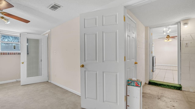 hall with a textured ceiling