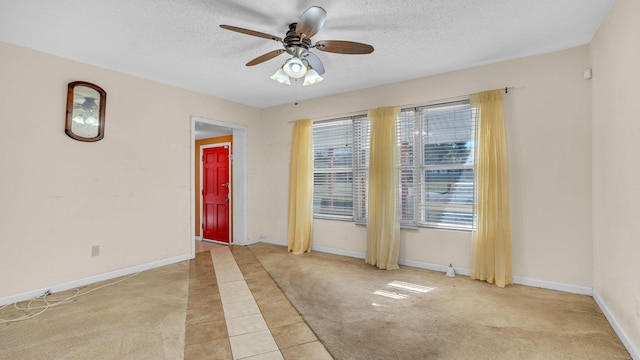 tiled spare room featuring ceiling fan and a textured ceiling