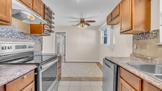 kitchen featuring light tile patterned floors, sink, ceiling fan, stainless steel appliances, and tasteful backsplash