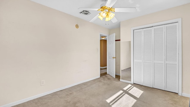 unfurnished bedroom with light carpet, ceiling fan, and a closet