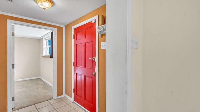 entrance foyer with light tile patterned floors and a textured ceiling