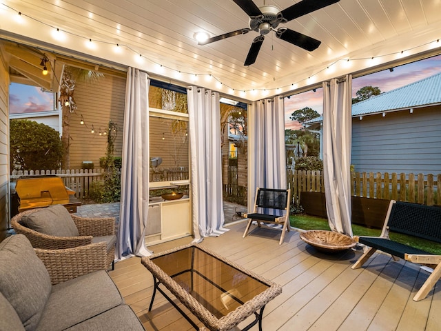 sunroom featuring ceiling fan