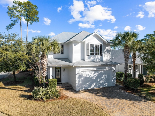 view of front property featuring a garage and a front yard