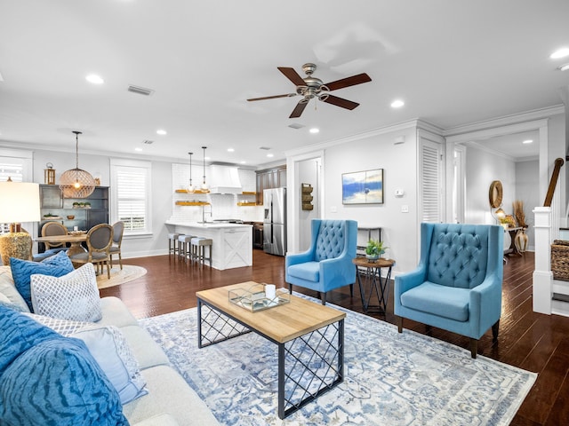 living room with crown molding, ceiling fan, and dark hardwood / wood-style flooring