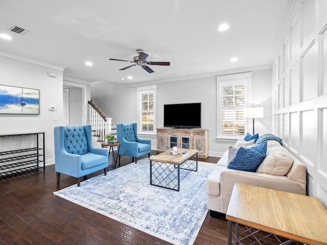 living room featuring ceiling fan, a wealth of natural light, ornamental molding, and dark hardwood / wood-style floors