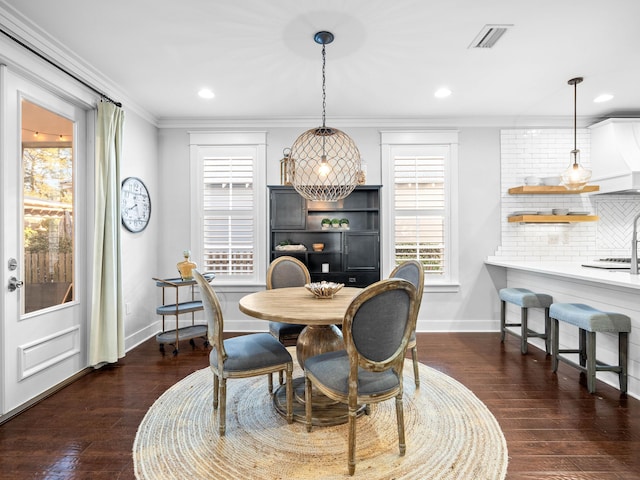 dining space featuring crown molding and dark hardwood / wood-style flooring