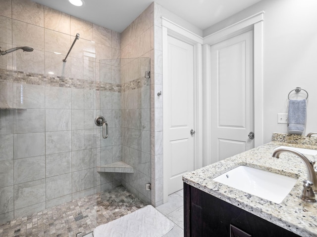 bathroom featuring an enclosed shower, vanity, and tile patterned flooring