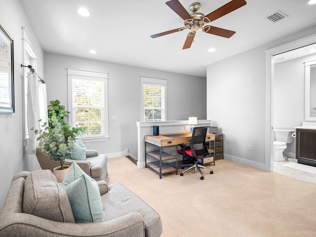 carpeted office space featuring ceiling fan