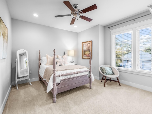 bedroom featuring light colored carpet and ceiling fan