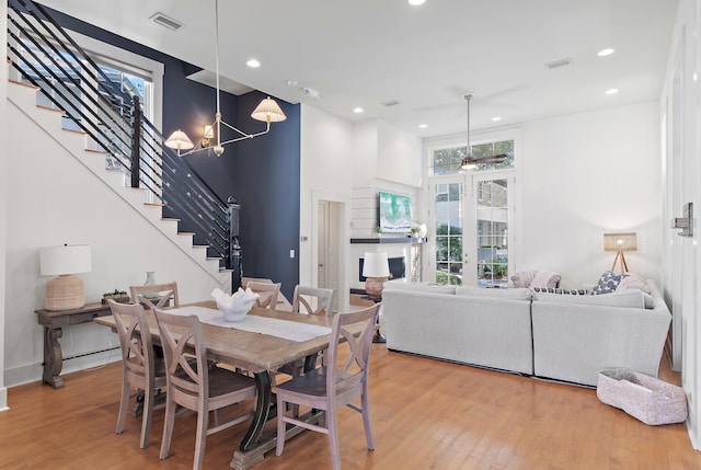 dining area with wood-type flooring and a notable chandelier