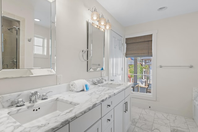 bathroom with vanity and a shower with door