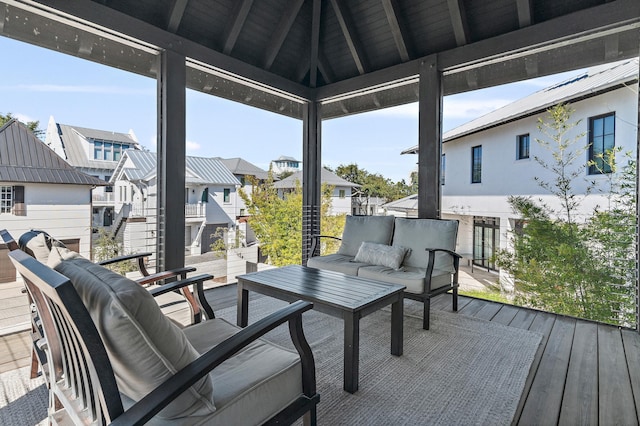 sunroom / solarium with vaulted ceiling with beams