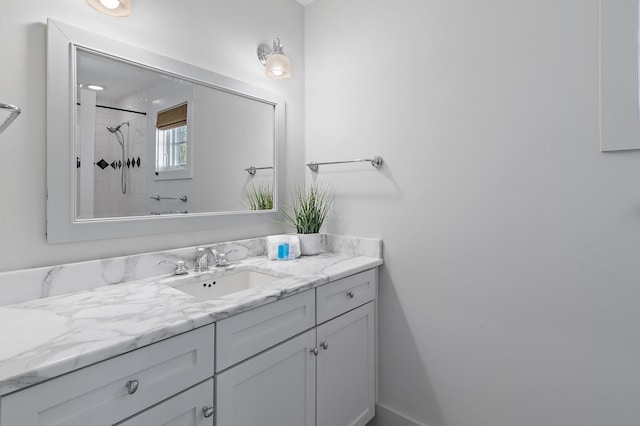 bathroom featuring vanity and tiled shower