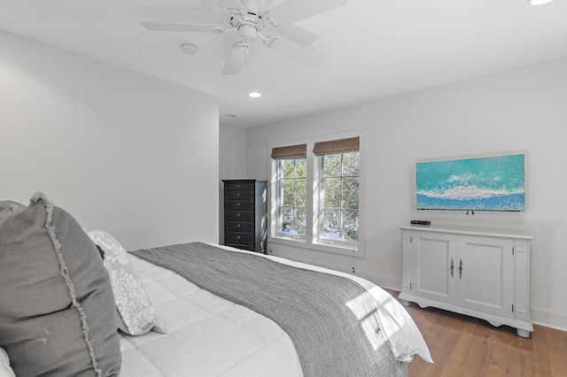 bedroom with ceiling fan and wood-type flooring