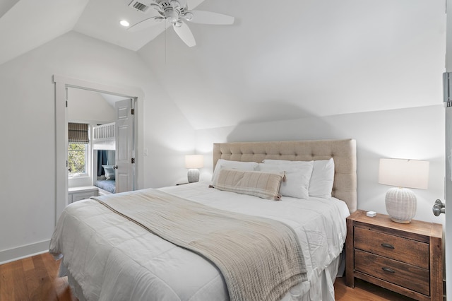 bedroom with hardwood / wood-style flooring, vaulted ceiling, and ceiling fan