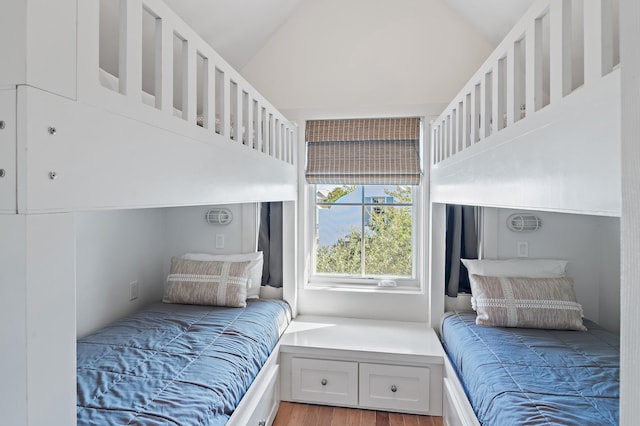 bedroom featuring lofted ceiling and hardwood / wood-style flooring