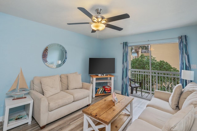 living room with ceiling fan and light wood-type flooring