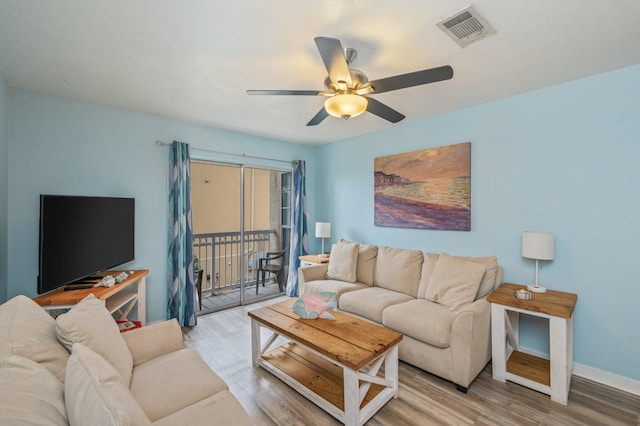 living room featuring hardwood / wood-style floors and ceiling fan