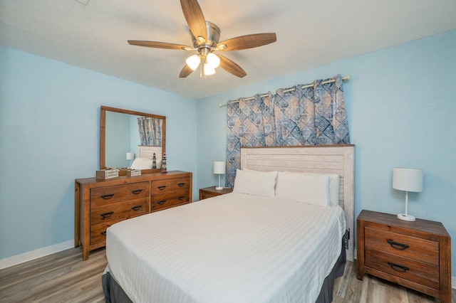 bedroom featuring hardwood / wood-style floors and ceiling fan