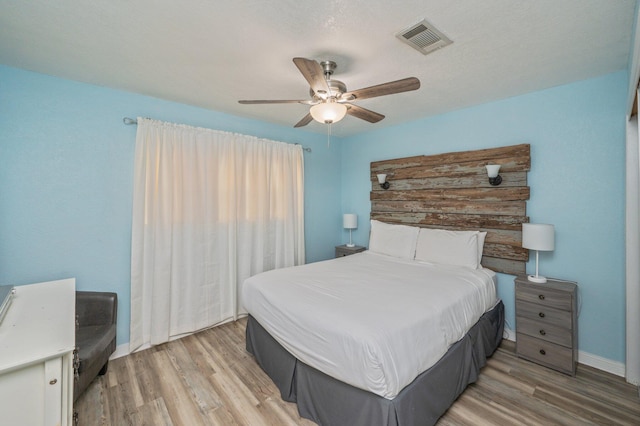 bedroom with ceiling fan and light wood-type flooring