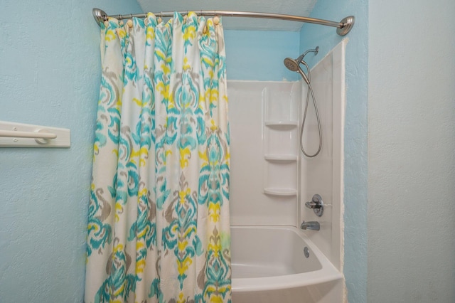 bathroom with shower / bath combination with curtain