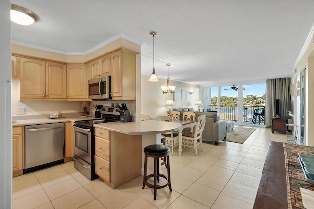 kitchen with light brown cabinetry, pendant lighting, ornamental molding, expansive windows, and stainless steel appliances