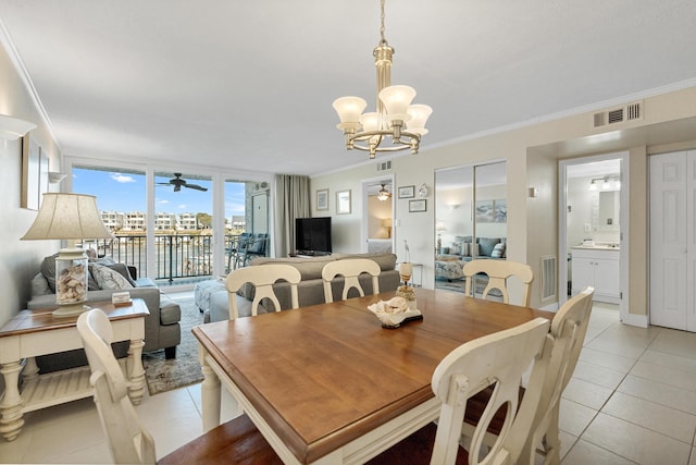 dining space with expansive windows, crown molding, ceiling fan with notable chandelier, and light tile patterned floors