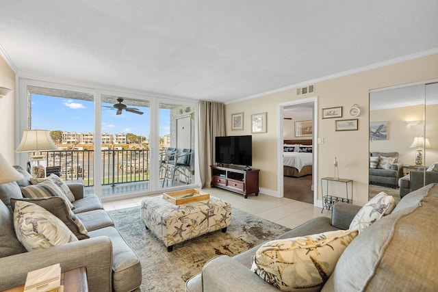 living room with light tile patterned floors, ornamental molding, and ceiling fan