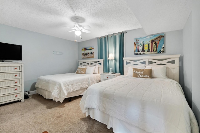 bedroom featuring carpet flooring, a textured ceiling, and ceiling fan