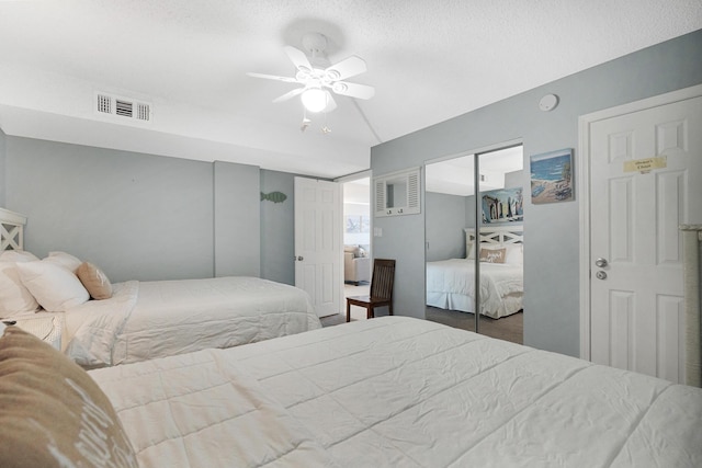 bedroom with a textured ceiling and ceiling fan