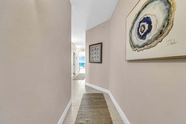 hall featuring light tile patterned floors