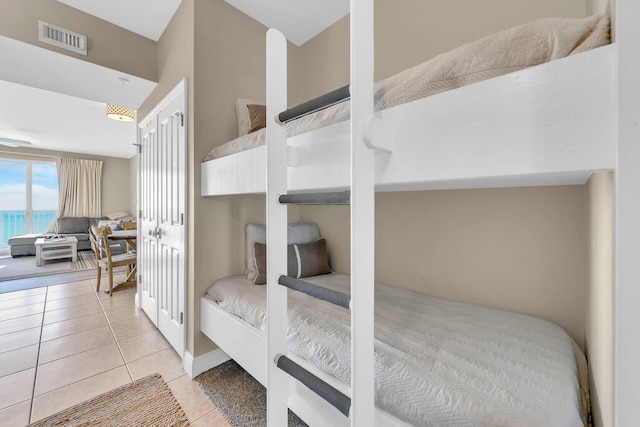 bedroom with light tile patterned floors