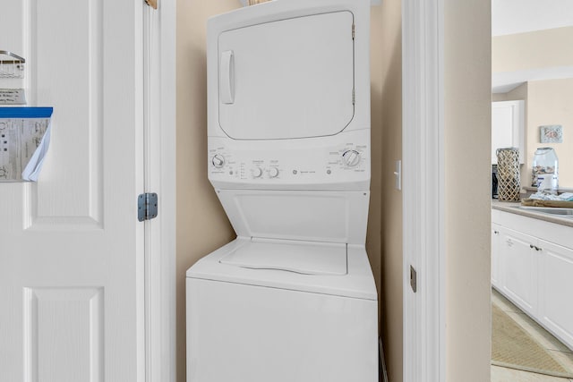 laundry room featuring stacked washer and clothes dryer