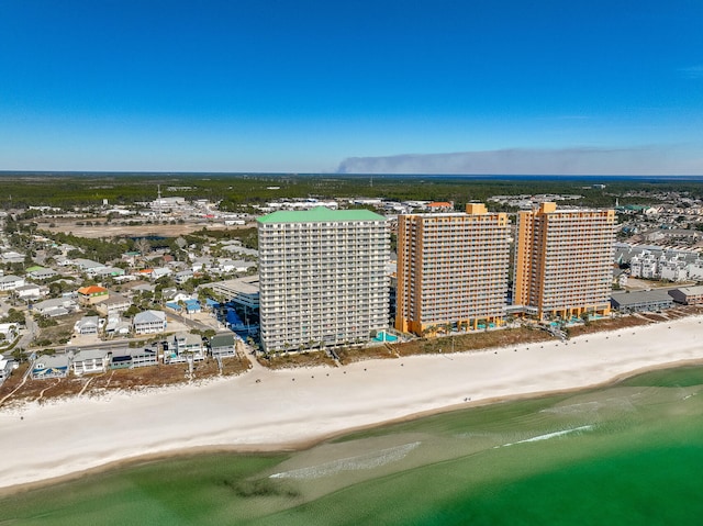 birds eye view of property with a water view and a beach view