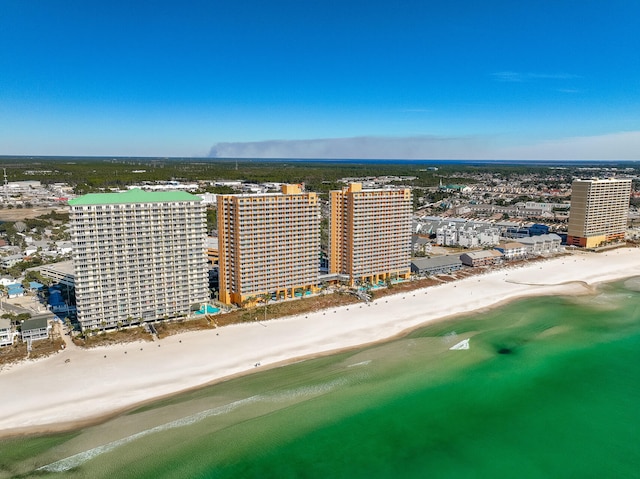 drone / aerial view with a water view and a beach view