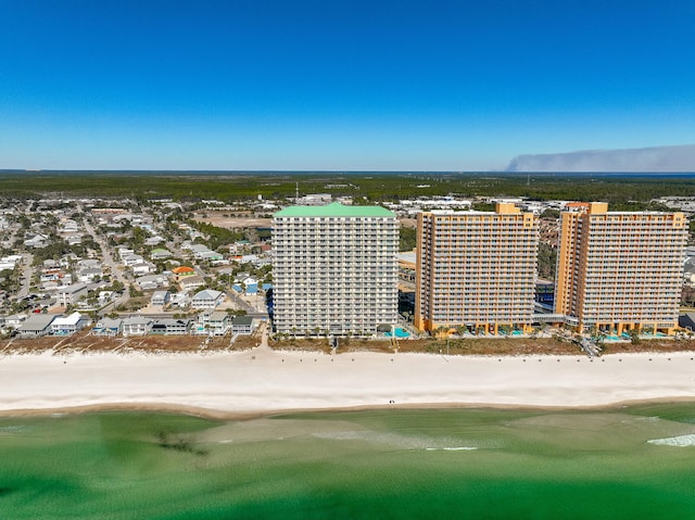 bird's eye view featuring a water view and a beach view