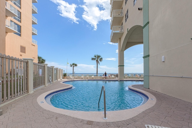 view of pool featuring a water view