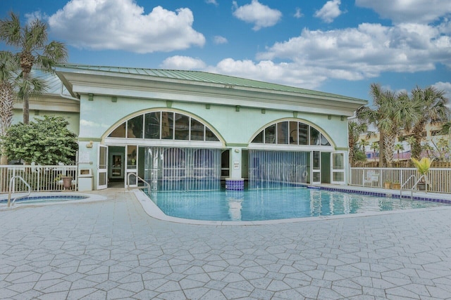 view of pool featuring a patio area and a community hot tub