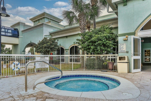 view of swimming pool featuring a patio area and a community hot tub