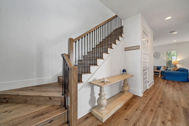 stairway featuring hardwood / wood-style floors