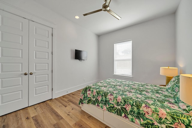 bedroom featuring hardwood / wood-style flooring, a closet, and ceiling fan